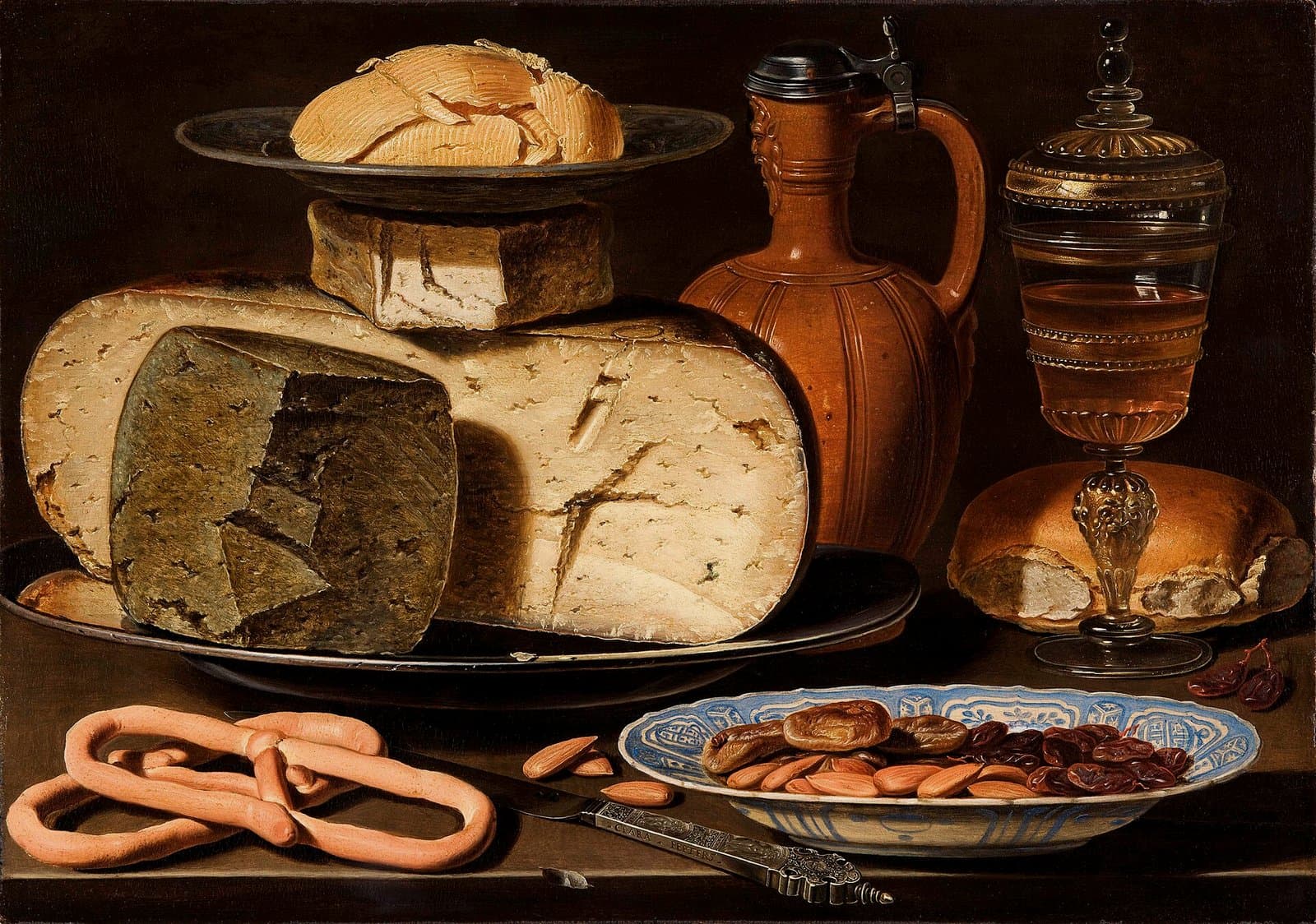 A still life of almonds with cheese on a dark table